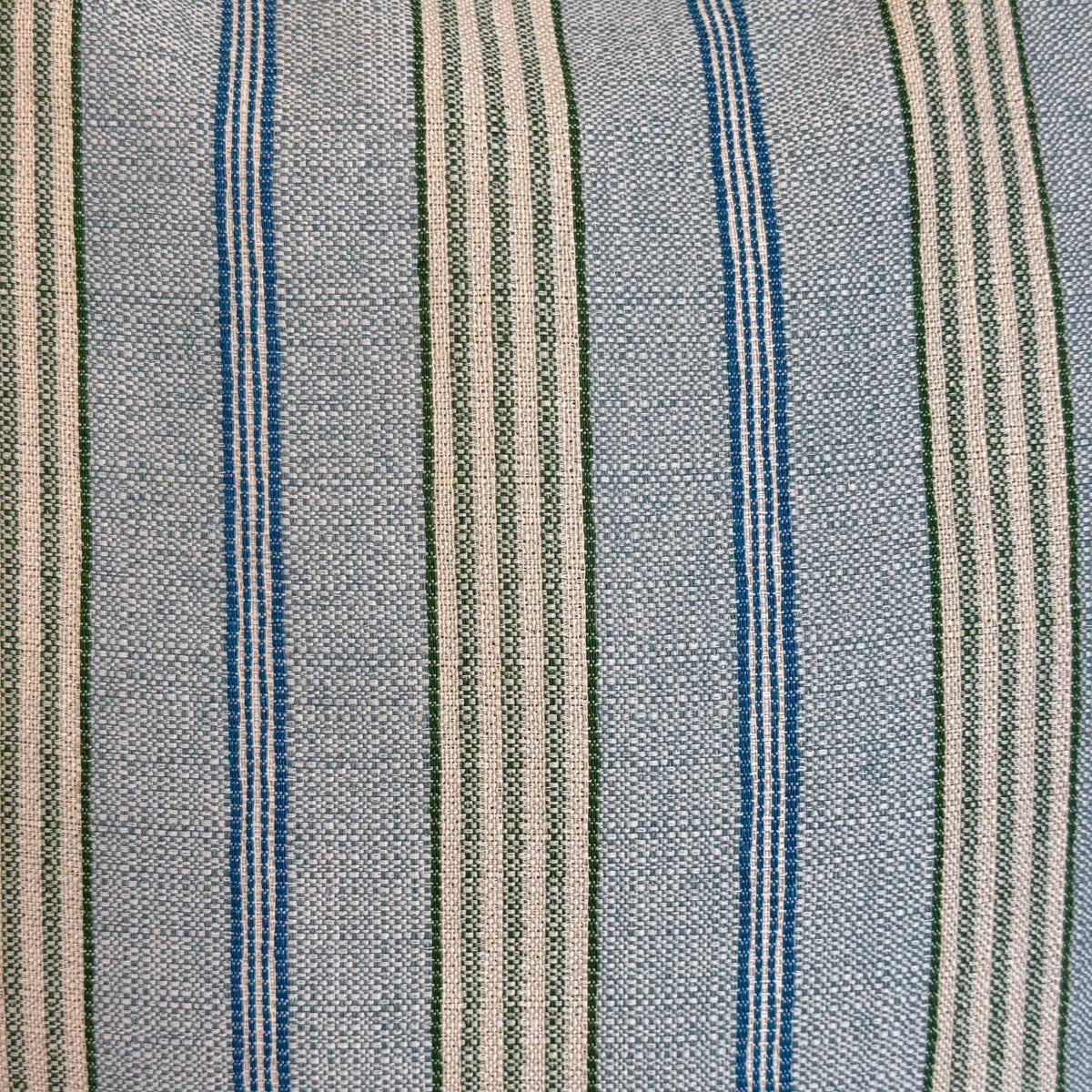 A close-up of the Striped Jacquard Small Makeup Bag – Blue & Green (Cata) by DE LA MUR LINE US Inc shows its woven jacquard texture, with vertical blue and green stripes on a light beige background—a testament to the high-quality materials used in this Barcelona-made accessory.