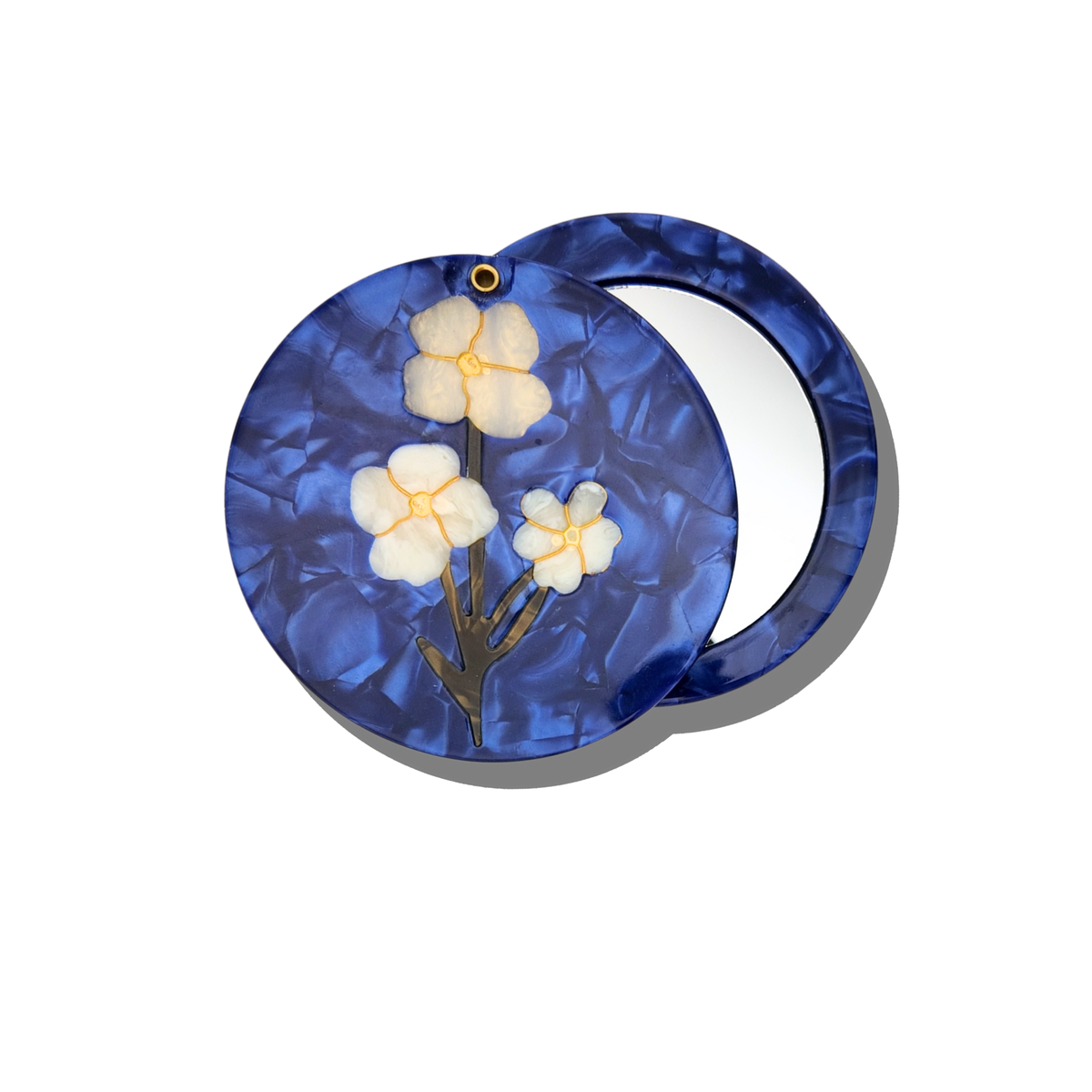 This is the Solar Eclipse Hand-painted Vintage Flowers Compact Mirror, featuring a round blue biodegradable acetate case with a marbled pattern.