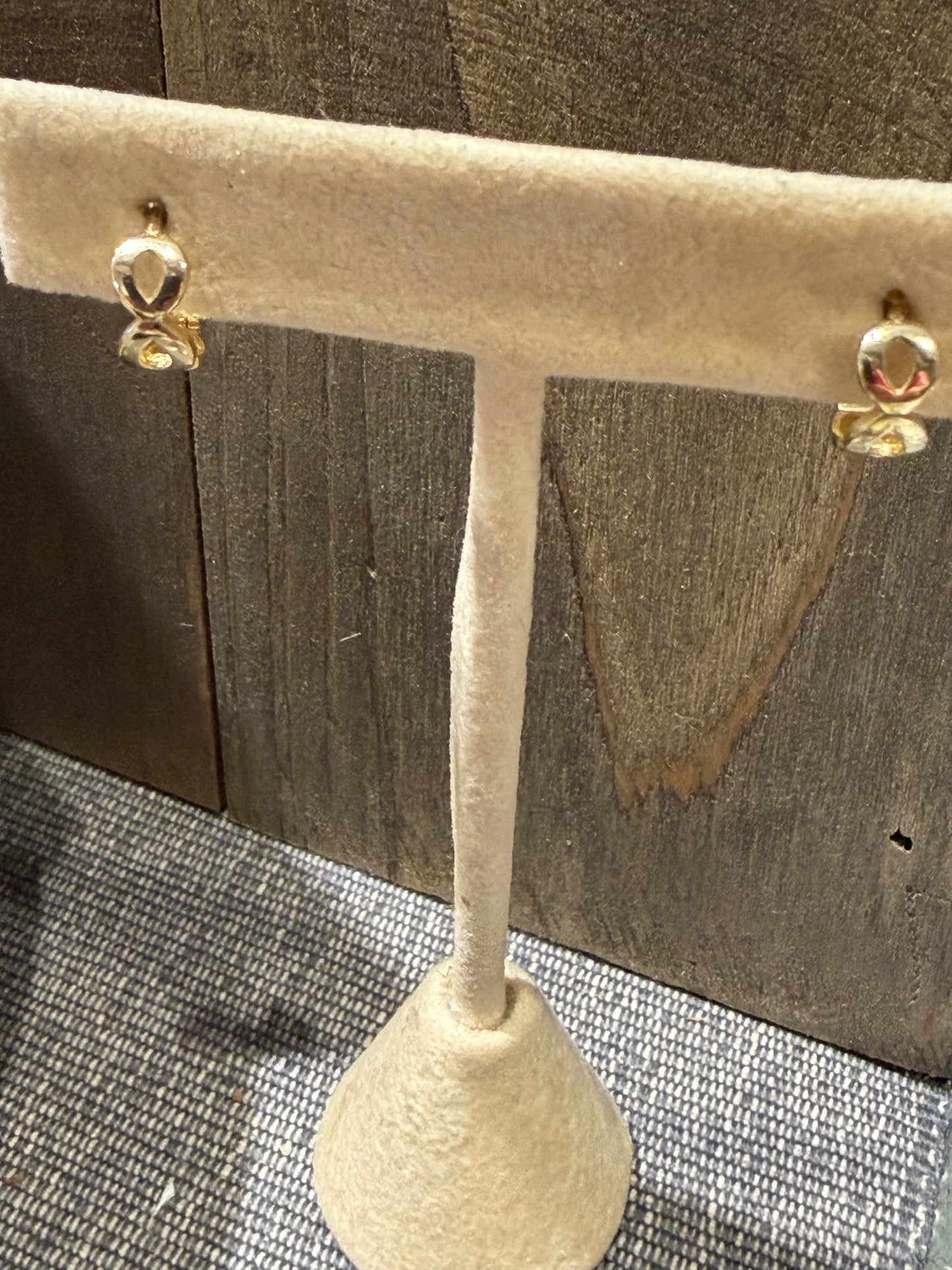 PK Fine 14k Solid Gold Unique Hoops featuring a small, stacked figure-eight design displayed on a stand.