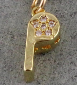 The DIYH Gold Sparkly Whistle Necklace features a gold filled whistle charm adorned with a star-shaped pattern of small clear gemstones, creating an CZ-encrusted pendant, beautifully displayed against a gray textured background.