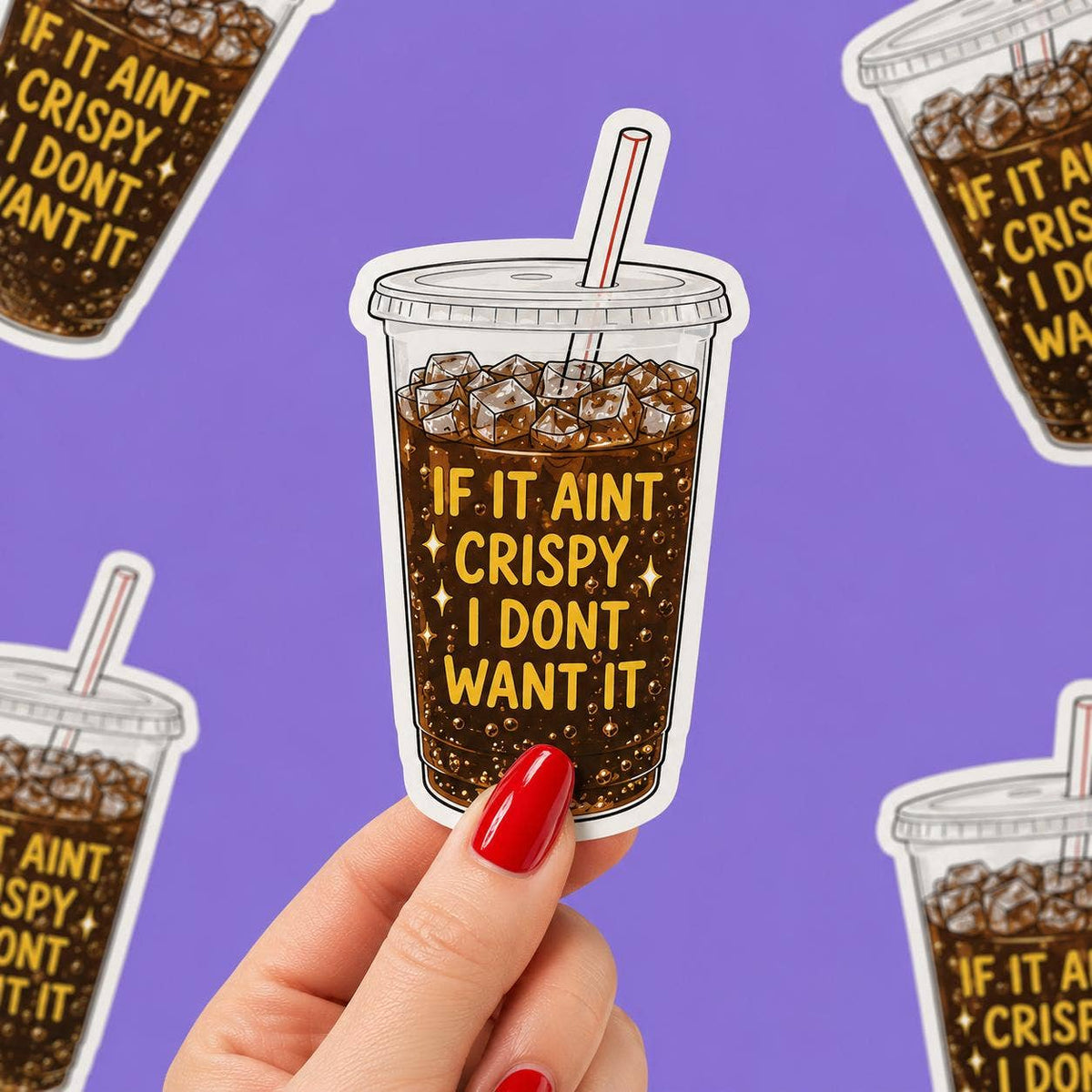 A hand with red nail polish holds the Funny Crispy Diet Coke sticker - Matte Vinyl by Hello Brand | Sticker My Art, featuring “IF IT AINT CRISPY I DONT WANT IT” on an iced drink against a purple background.