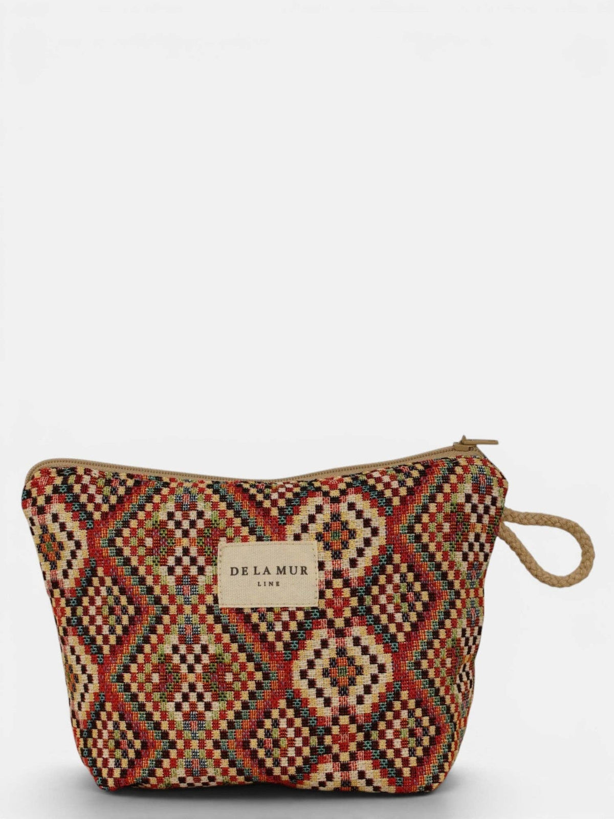 A zippered fabric pouch, the Geometric Jacquard Small Makeup Bag – Red Multicolor (Otto) by DE LA MUR LINE US Inc, crafted from jacquard fabric with a geometric red, yellow, and brown pattern and finished with a beige handle. This stylish accessory features a front label reading “DE LA MUR LINE US.” Set against a plain white background.