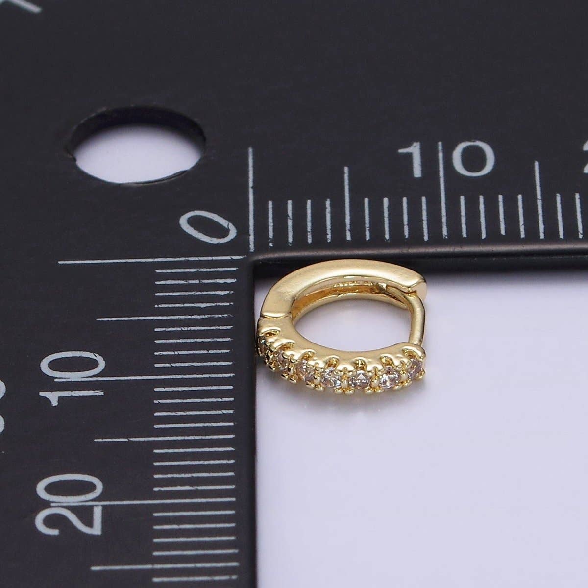 Aim Eternal Tiny CZ Clicker Hoops - Gold Filled 10mm shown next to a measuring ruler.