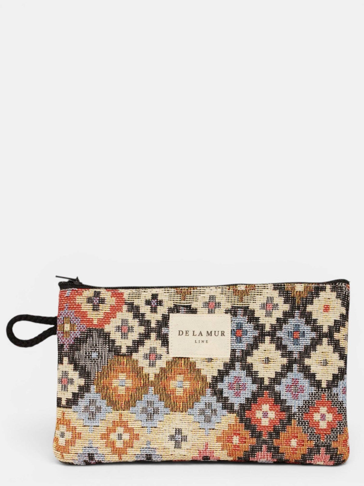 Introducing the Geometric Jacquard Small Makeup Bag / Coin Purse – Multicolor (Ore) by DE LA MUR LINE US Inc, a rectangular zippered pouch crafted from vibrant jacquard fabric with a colorful geometric pattern and a handy small handle. Ideal for use as a makeup bag or coin purse, it features the DE LA MUR LINE label on the front.
