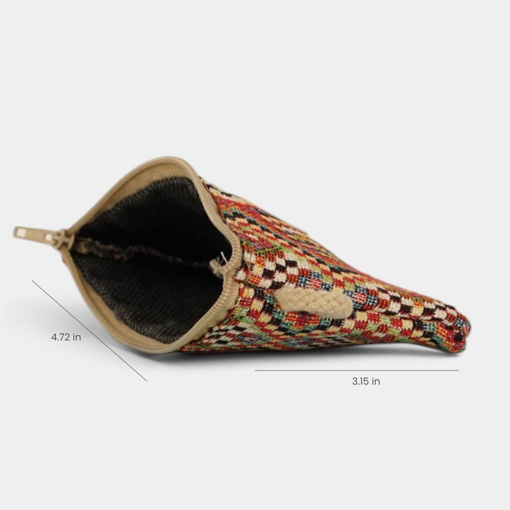 The Geometric Jacquard Coin Purse – Red Multicolor (Otto) by DE LA MUR LINE US Inc is displayed on its side, featuring a vibrant woven jacquard fabric pattern and a zippered closure. Made in Barcelona, it measures 4.72 inches in length and 3.15 inches in width.