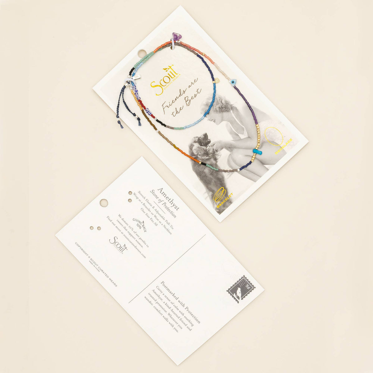 Two postcards on a beige surface: one features the Mixed Media Wrap Bracelet/Necklace - Protection/Amethyst/Gold by Scout Curated Wears, its elegant amethyst beads and gold accents reminiscent of handmade artistry, displayed beside a black-and-white photograph; the other highlights product details and a small stamp in the corner, evoking the charm of artisanal jewelry.