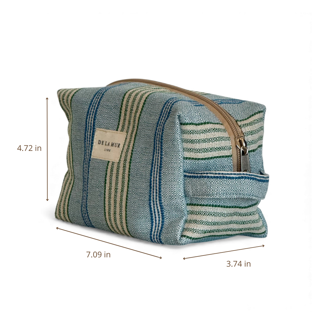 The Striped Jacquard Squared Makeup Bag – Blue & Green (Cata) by DE LA MUR LINE US Inc is crafted from jacquard fabric with a zipper closure. Made in Barcelona, this makeup bag measures 4.72 inches tall, 7.09 inches wide, and 3.74 inches deep.