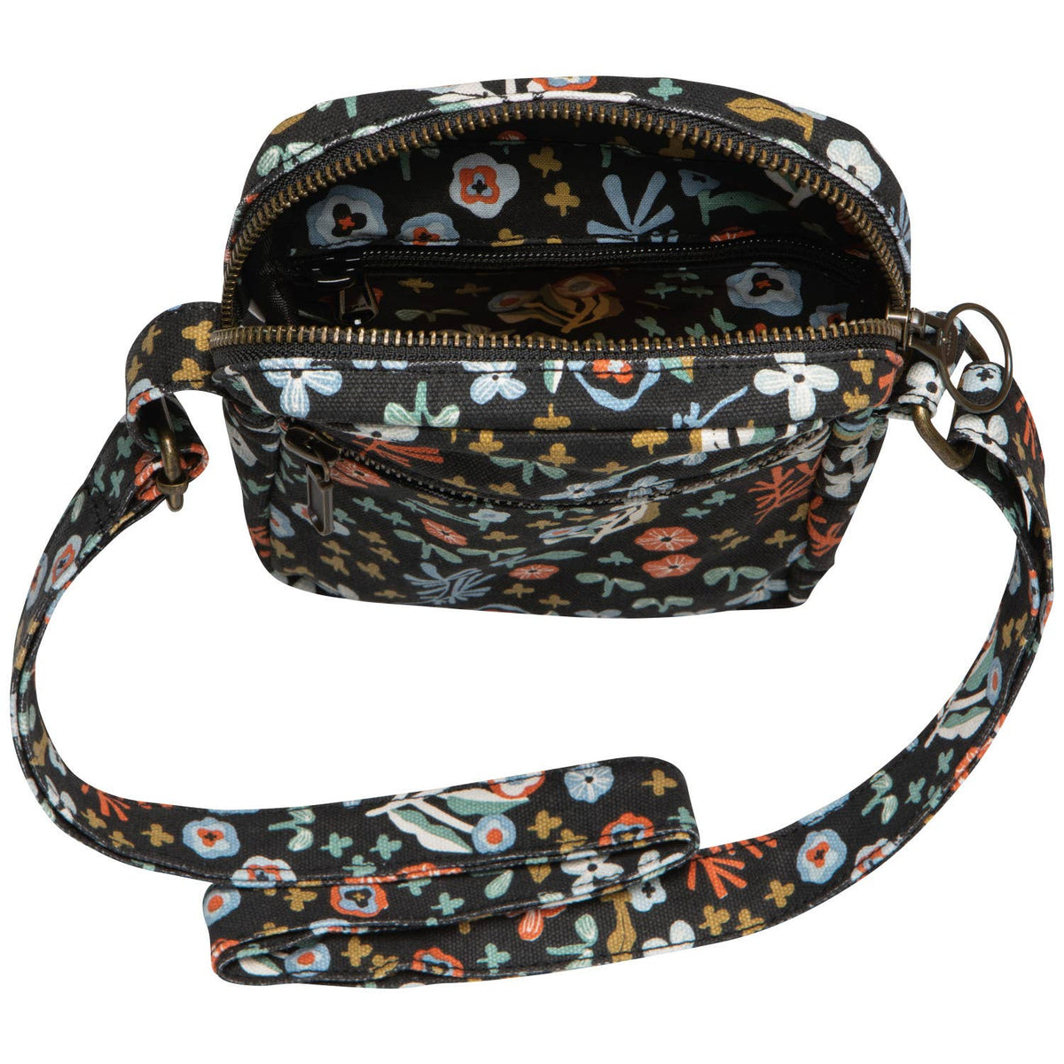 Danica Studio Dogwood Cotton Crossbody Bag in Multi Floral/Black, a black cotton canvas bag featuring a colorful floral pattern with an open zippered top and an adjustable strap.