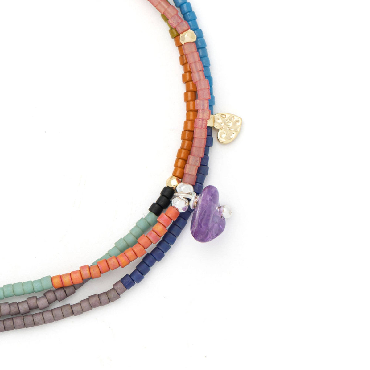 Add a touch of elegance to your look with the Mixed Media Wrap Bracelet/Necklace – Protection/Amethyst/Gold by Scout Curated Wears. This versatile piece features colorful square beads in pink, orange, green, blue, purple, and black—crafted from Japanese Miyuki beads—and is accented with charming details like a gold heart and a purple stone. Designed for those who appreciate hypoallergenic jewelry options, it makes an ideal companion to your favorite amethyst bracelet.