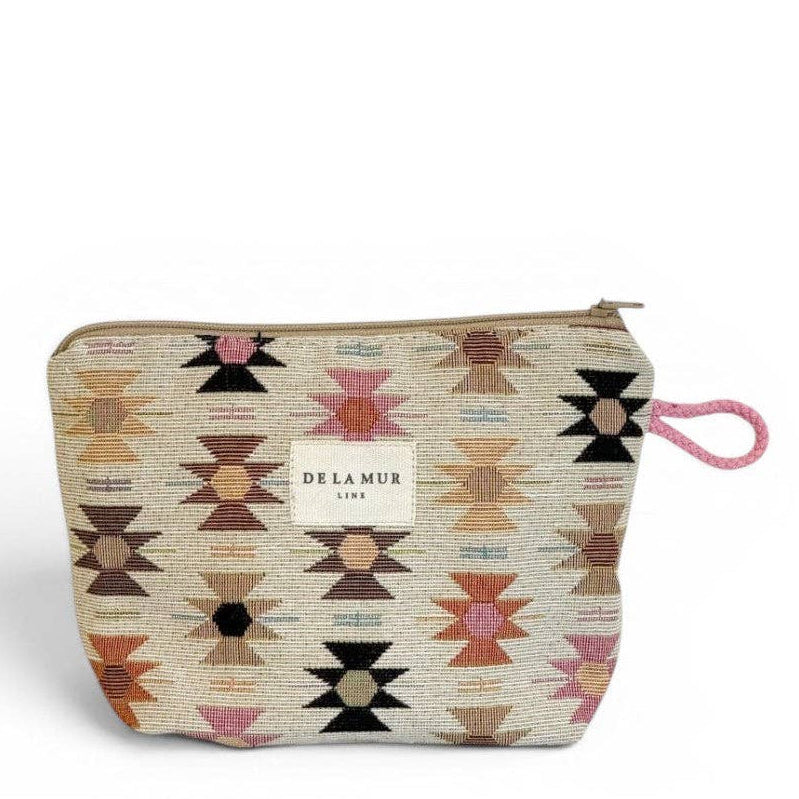 The Geometric Jacquard Small Makeup Bag – Pink & Orange (Royal) by DE LA MUR LINE US Inc features a vibrant Aztec geometric pattern in multicolor jacquard fabric, a zip closure, a small DE LA MUR label, and a pink side loop. It is displayed against a plain white background.