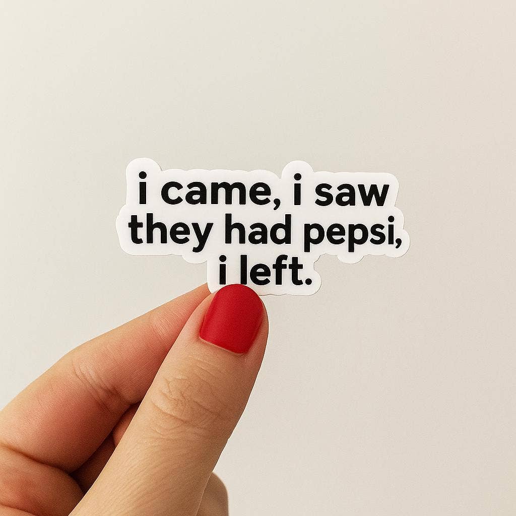 A hand with red nail polish holds a matte finish Funny “I came, I saw they had pepsi, i left” Sticker by Hello Brand | Sticker My Art against a plain white background.