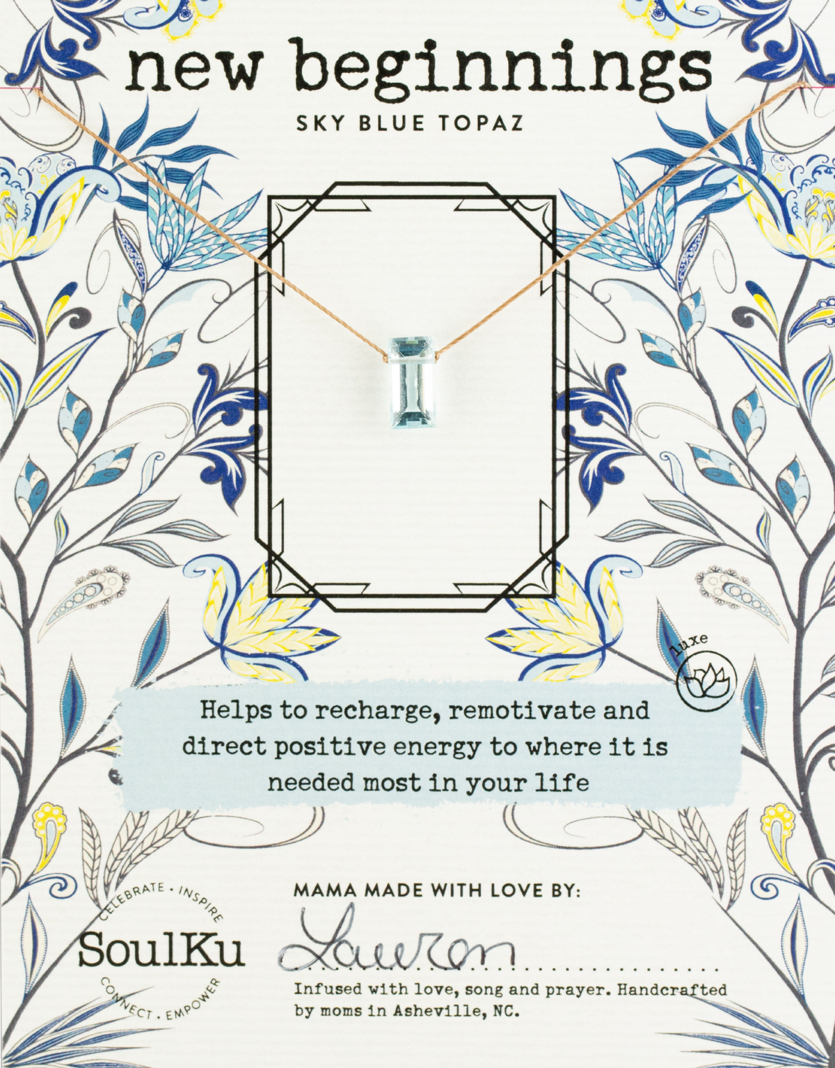 The SoulKu Sky Blue Topaz Refined Necklace for New Beginnings is presented on a floral card, with its uplifting pendant said to boost energy amid blue and yellow flower designs.
