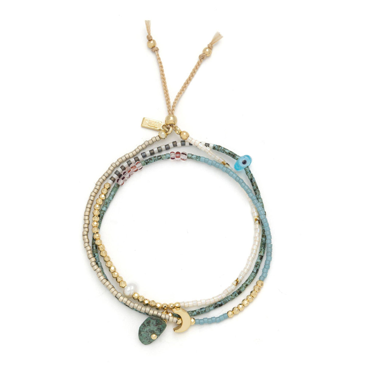 Introducing the Mixed Media Wrap Bracelet/Necklace - Transformation/African Turquoise by Scout Curated Wears: a versatile, multi-strand accessory crafted with shimmering gold and Miyuki beads, accented in white and vibrant blue. This adjustable piece features small charms—including a gold crescent and an eye—as well as African Turquoise stones, all finished with a gold adjustable chain closure for the perfect fit.
