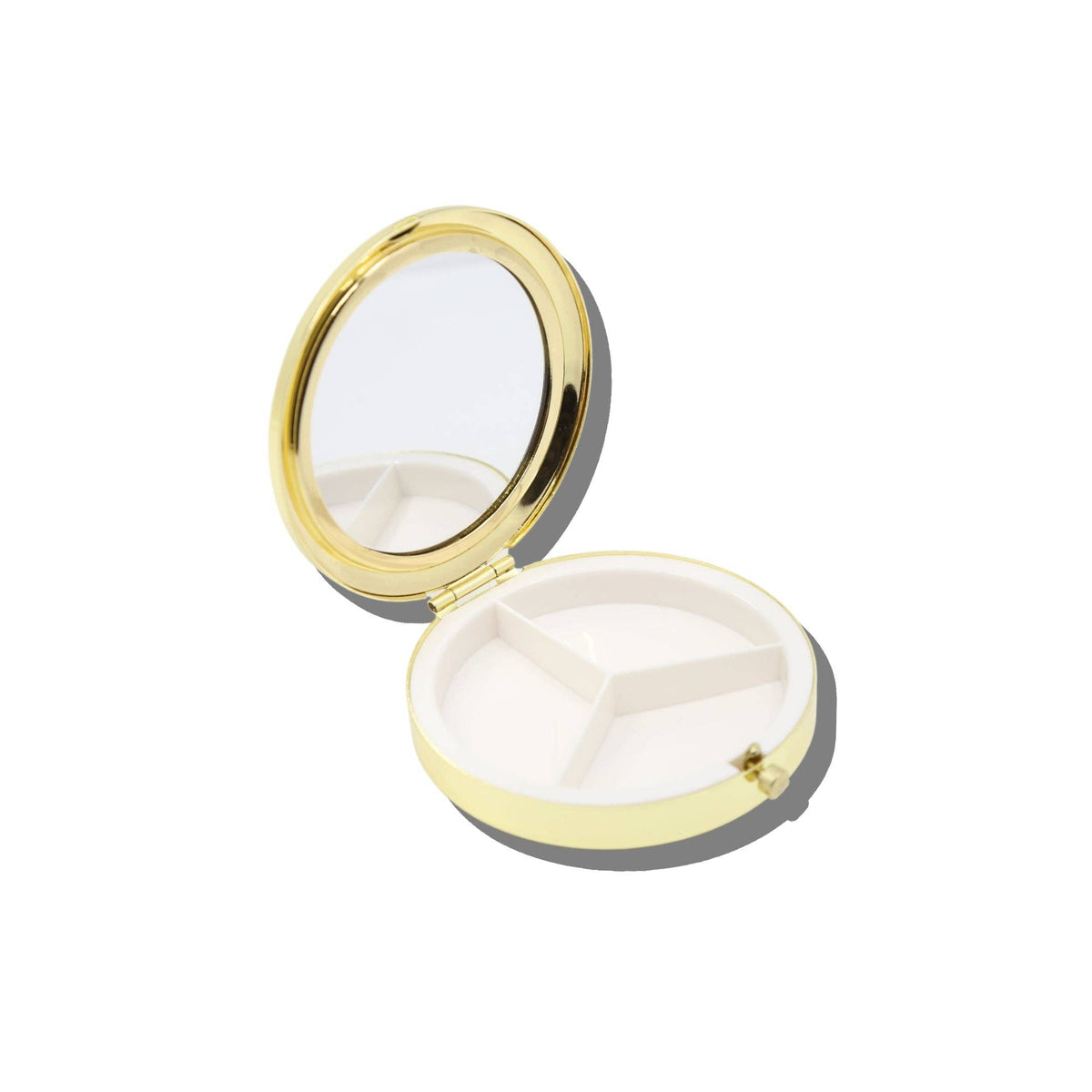 Open Solar Eclipse Pink Drugs Handbag Hero Pill Compact, a round gold case revealing a white interior divided into three sections.