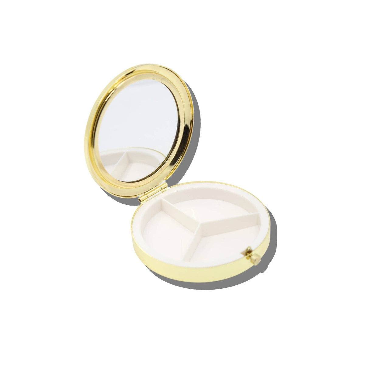 Open gold-toned Caviar Handbag Hero Pill Compact - Hand-Painted with an interior mirror and a white pill tray divided into three sections.