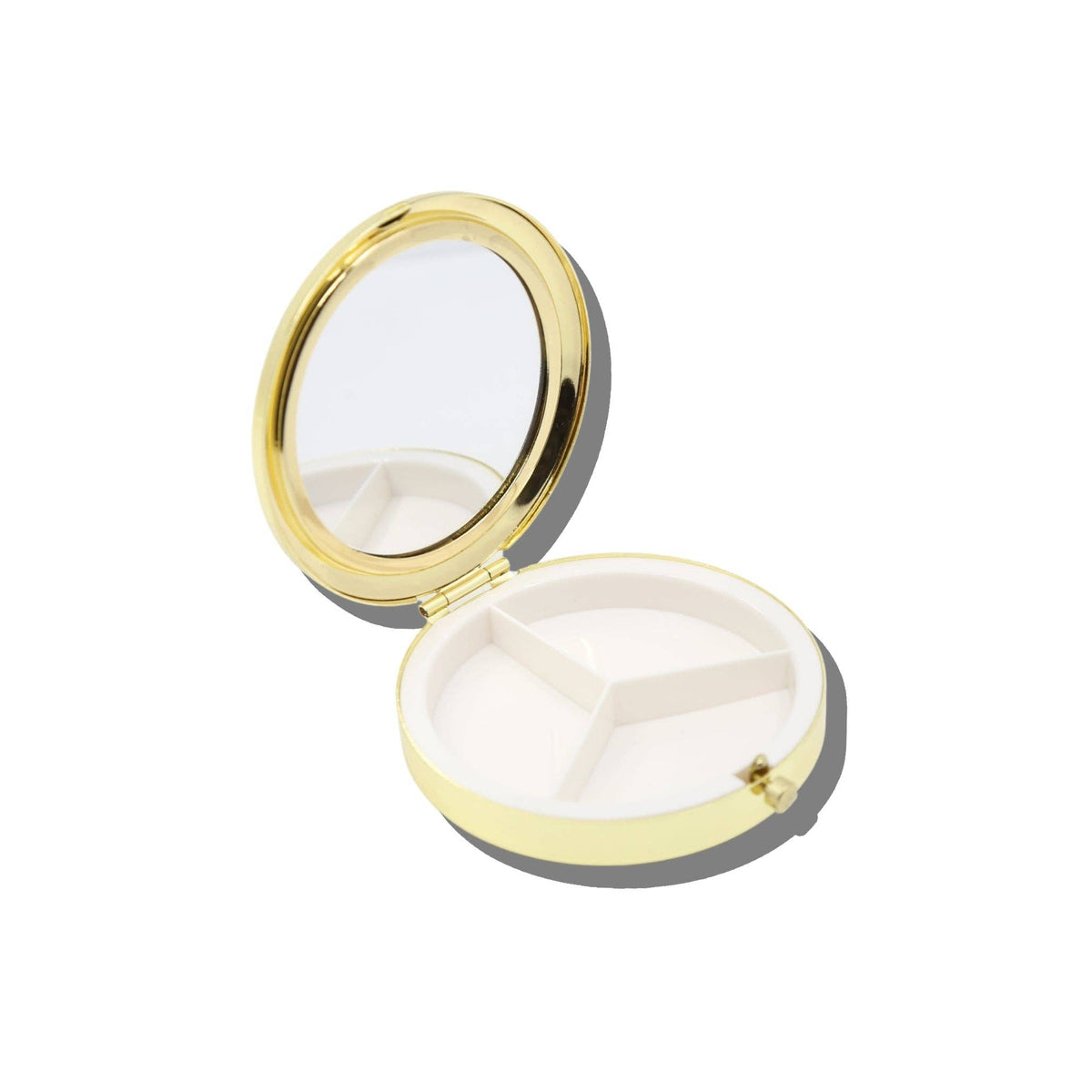 Open gold Cross-Stitch Drugs Handbag Hero Pill Compact featuring a mirror in the lid and three interior compartments.
