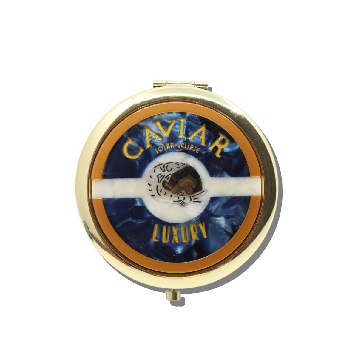 A gold, round, vintage-inspired Solar Eclipse Caviar Handbag Hero Pill Compact - Hand-Painted featuring a blue and white swirled inlay with a central fish illustration, reading CAVIAR at the top and LUXURY at the bottom.