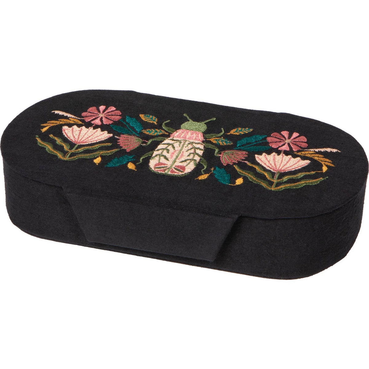 Oval black Danica Studio Amulet Embroidered Jewelry Box with floral and beetle embroidery on the lid, serving as a charming tabletop accent.