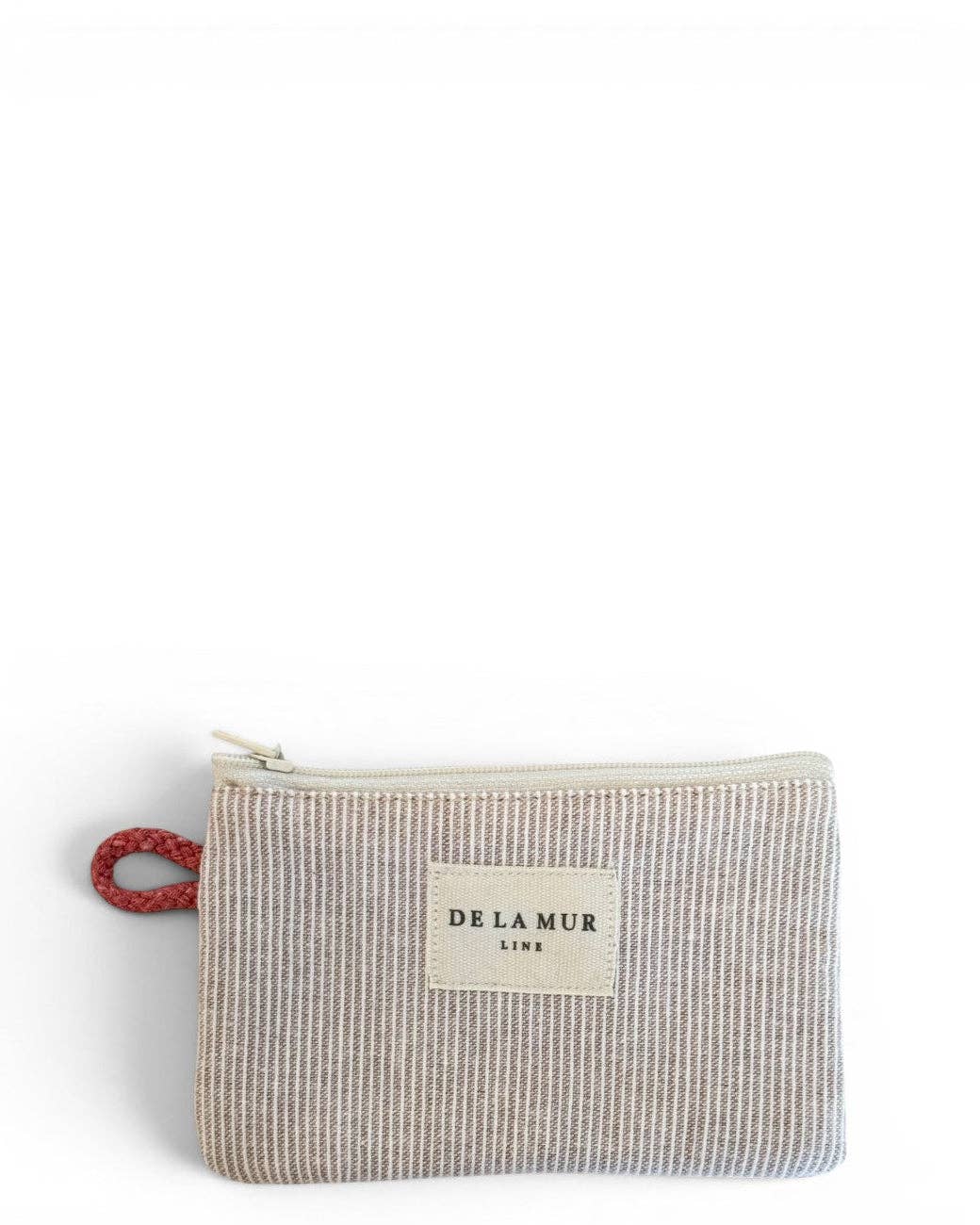 Here’s a rewritten version of your sentence using the provided product data: The Striped Coin Purse – Gray & Cream by DE LA MUR LINE US Inc is a compact zippered coin purse, crafted from jacquard fabric with slim vertical stripes in gray and cream, featuring a red fabric loop on the left side and a front label displaying the brand name—made in Barcelona.