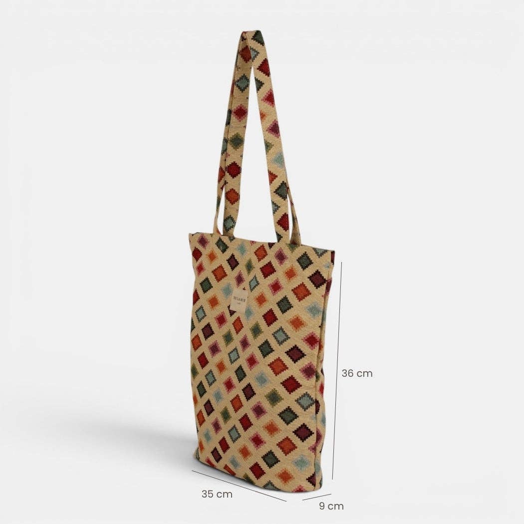 Introducing the DE LA MUR LINE US Inc Geometric Jacquard Medium Zippered Tote Bag – Multicolor (Zac): this stylish tote showcases a vibrant geometric pattern with red, blue, yellow, and black diamond shapes on premium jacquard fabric. Designed with long handles for comfortable carrying, the bag’s dimensions are clearly marked at 36 cm tall, 35 cm wide, and 9 cm deep.