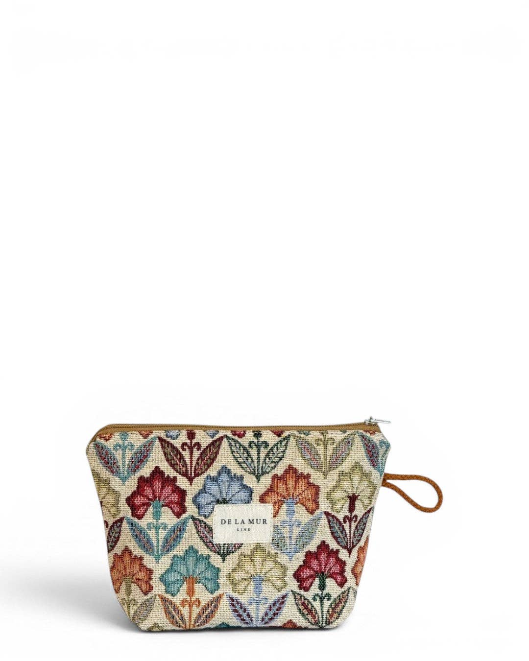 The Floral Jacquard Small Makeup Bag – Multicolor (Flora) by DE LA MUR LINE US Inc is a compact pouch crafted from jacquard fabric with a vibrant floral tapestry pattern. It features a brown wrist strap and a front label displaying “DE LA MUR,” shown against a plain white background.
