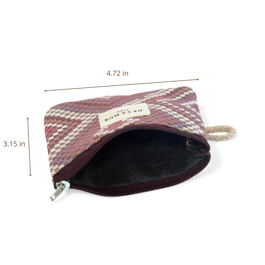 Geometric Jacquard Coin Purse – Pink & Lilac (Nana) by DE LA MUR LINE US Inc, featuring a woven brown and pink geometric kilim pattern. This small zippered fabric purse measures 4.72 inches wide by 3.15 inches tall and is crafted from jacquard fabric. The zipper is partially open to reveal the inner lining.