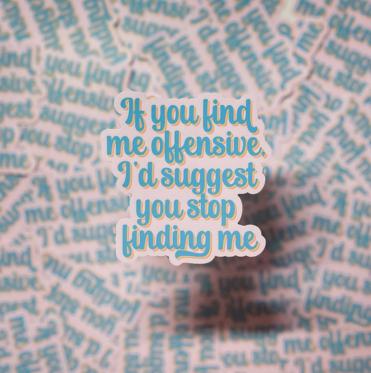 The If You Find Me Offensive... Sticker by Erin Dayhaw features blue text with a white outline on a blurred background repeating the same phrase.