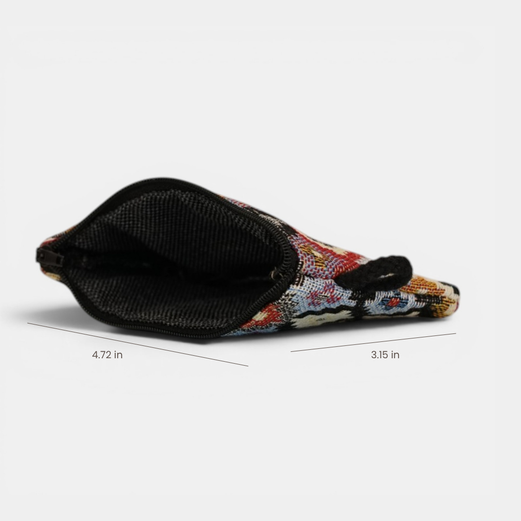 The Geometric Jacquard Coin Purse – Multicolor (Ore) by DE LA MUR LINE US Inc, featuring a small geometric pattern and crafted from jacquard fabric, is displayed flat on a white surface with its zippered opening facing forward. The purse measures 4.72 inches in length and 3.15 inches in width.