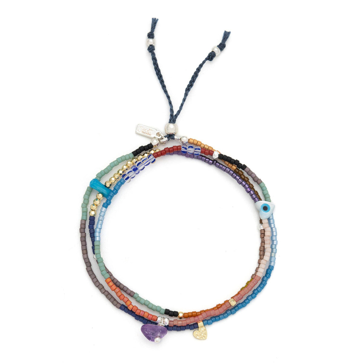 The Scout Curated Wears Mixed Media Wrap Bracelet/Necklace – Protection/Amethyst/Gold features multiple strands of vibrant Miyuki beads accented with small charms, including a purple amethyst stone, a gold heart, and a blue eye bead, all finished with an adjustable blue cord for the perfect fit.