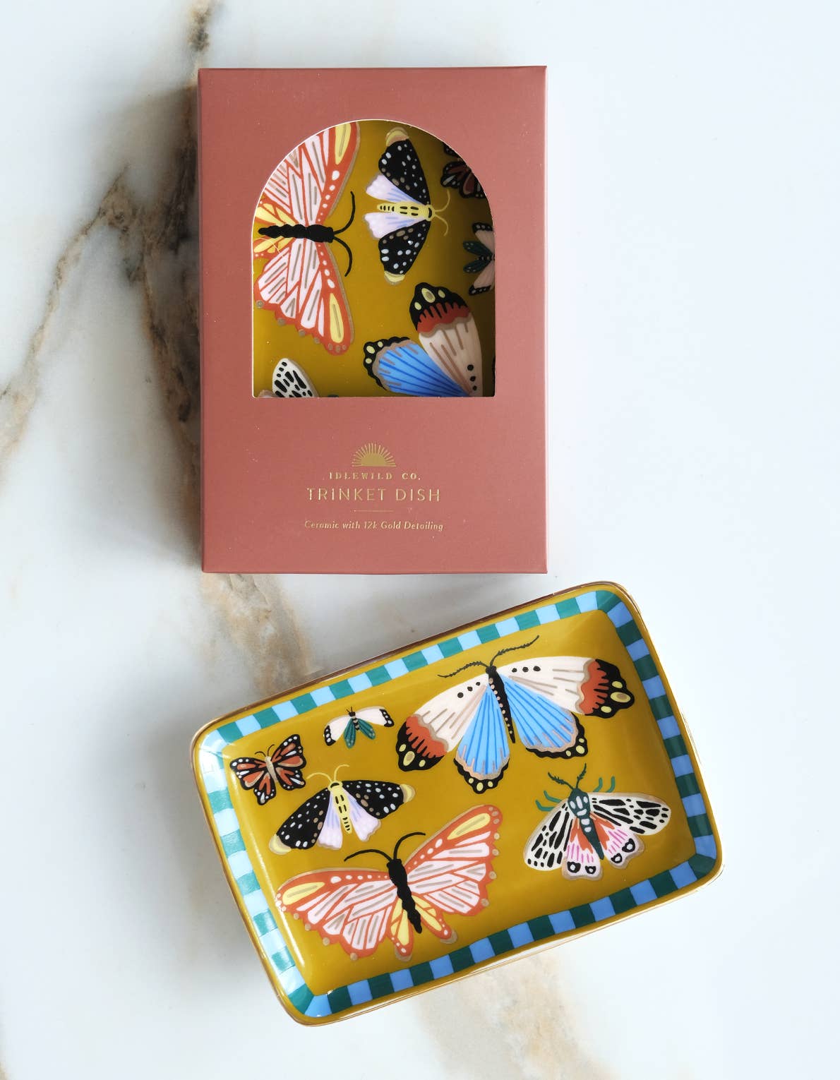 A rectangular Porcelain Trinket Tray - Butterflies with a mustard yellow background, colorful moth illustrations, and a teal striped border, shown alongside its matching storage box with elegant gold detailing.